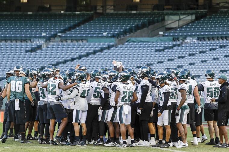 The Eagles gather before the start of practice at the Angles Stadium of Anaheim in Anaheim, California on Thursday, December 7, 2017. YONG KIM / Staff Photographer
