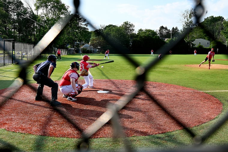 Jimmy Catania connects at the plate. His father, Joe Catania, who passed away last year, founded the team. The catcher is Kevin McGarrigle, and the umpire is Bill Kashatus, who is also the father of Ben, another player.