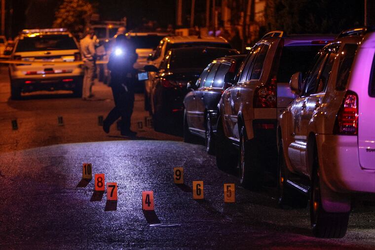 Police on the scene in the 100 block of East Albanus Street in Philadelphia's Olney section Wednesday night where a 30-year-old woman and her 2-year-old daughter were shot. The mother was in extremely critical condition, and the daughter in stable condition, police said.