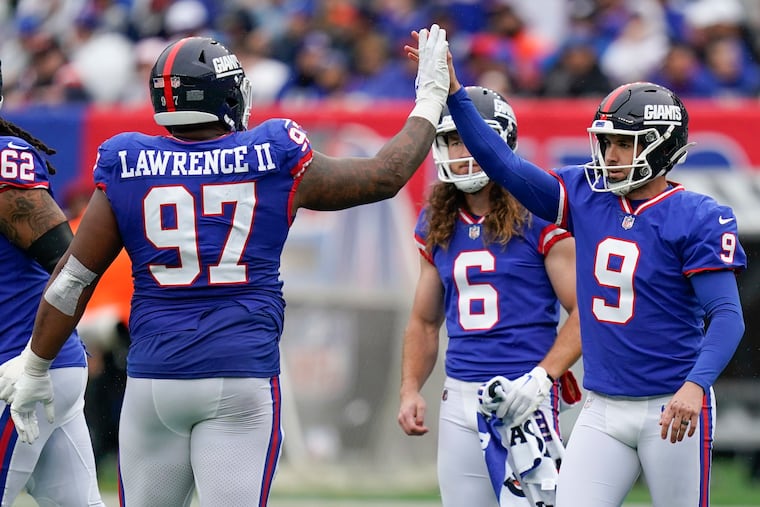 New York Giants place kicker Graham Gano (9) is congratulated by New York Giants defensive tackle Dexter Lawrence (97) after a successful field goal.