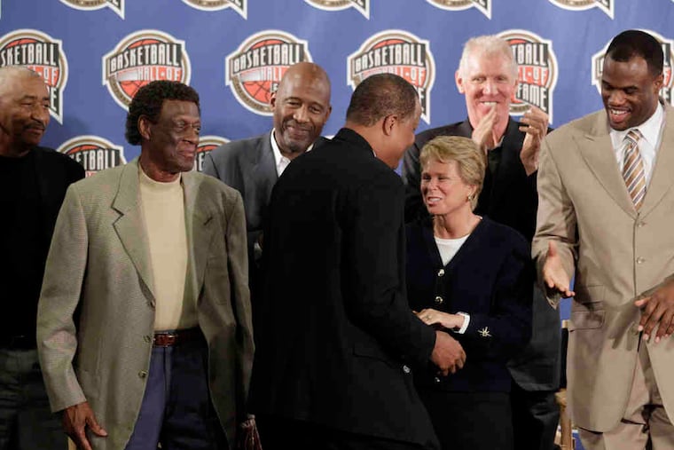 Hall of Fame finalist Jamaal Wilkes, a Showtime-era Lakers veteran, greets Ann Meyers Drysdale at an L.A. news conference with (from left) George Gervin, Elgin Baylor, James Worthy, Bill Walton, and David Robinson.