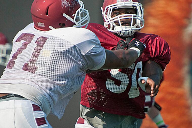 Temple defensive lineman Praise Martin-Oguike battles with a teammate. (Ron Tarver/Staff Photographer)