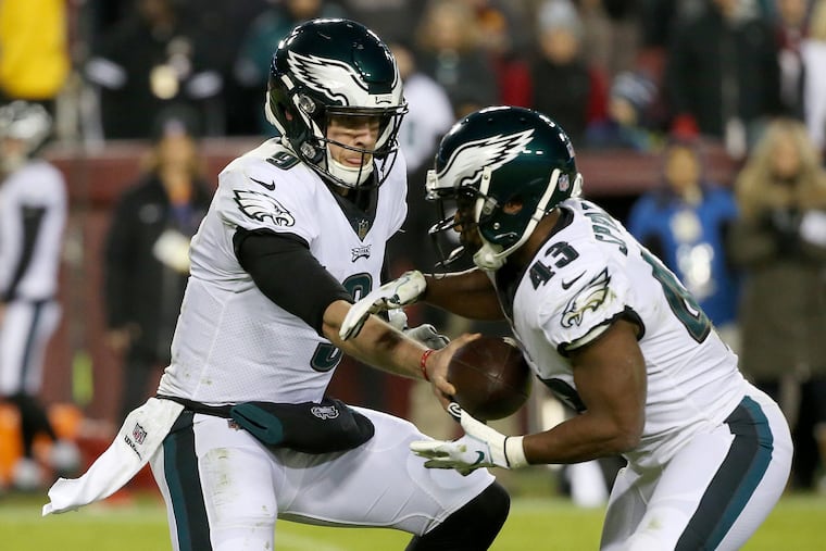 Eagles quarterback Nick Foles (9) hands the ball off to running back Darren Sproles (43) during a game against the Washington Redskins at FedEx Field in Landover, Md., on Sunday, Dec. 30, 2018.