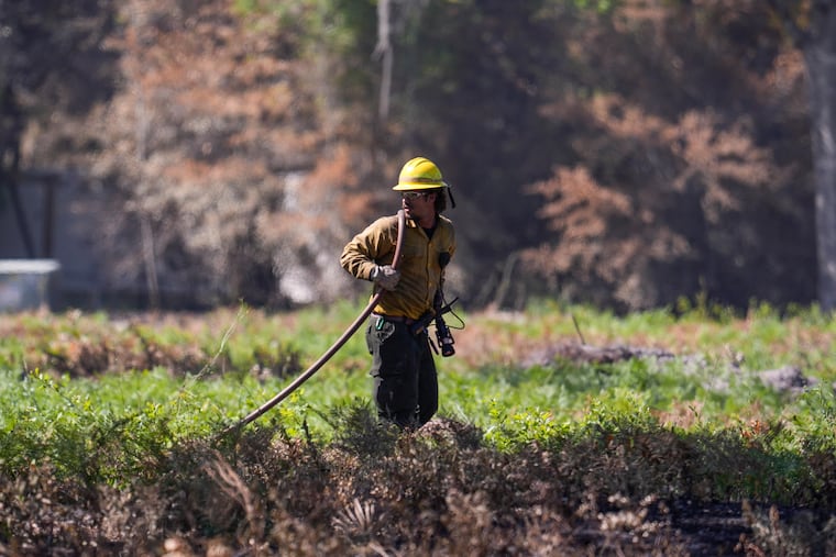 A firefighter works the Brantley Highway 82 fire Thursday near Nahunta, Ga.