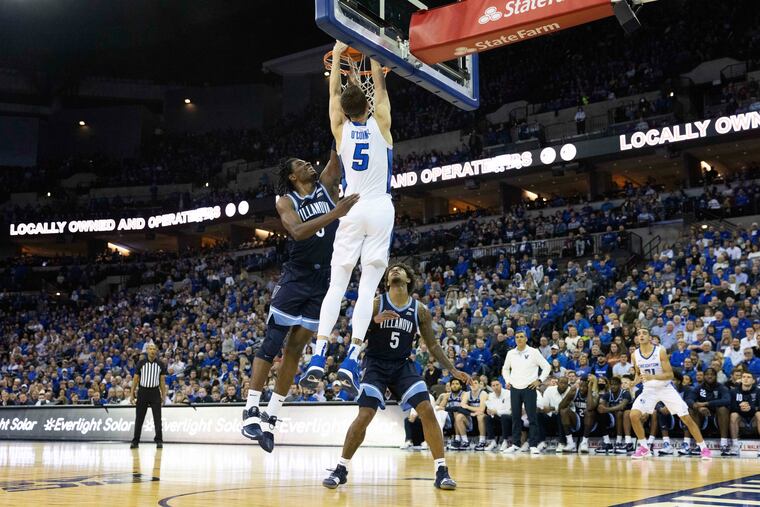 Creighton's Alex O'Connell (5) dunks against Villanova's Brandon Slater (3) and Justin Moore (5) during the first half on Friday, Dec. 17, 2021, in Omaha, Neb. The Bluejays scored 42 points in the paint.