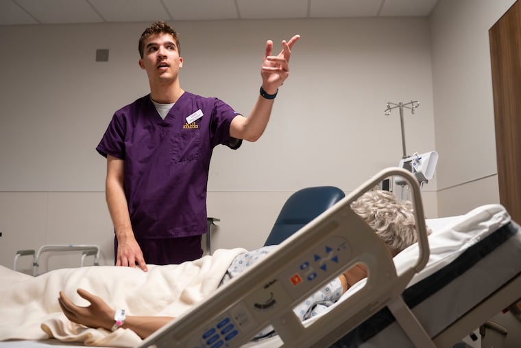 Adam Hudson, senior nursing student, gives a tour through the Duey Immersive Learning Center, a center for hands-on clinical and patient care simulations for the nursing program at West Chester University. The school held the event to celebrate 50 years of the nursing program at West Chester and to announce the university would start a School of Nursing.