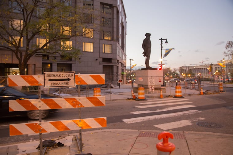 Gates close off what was once the Four Seasons Hotel and signs redirecting pedestrians.