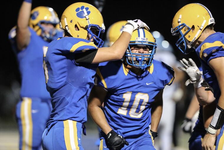Downingtown East's Garvey Jonassaint (10) celebrates after scoring a touchdown in a 61-44 nonlague win over North Penn last season.