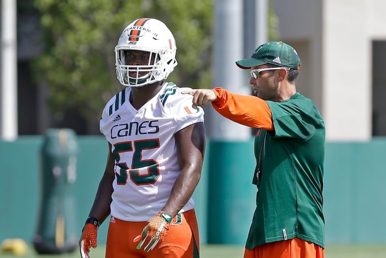 Manny Diaz (right) helped turn around Miami's defense.