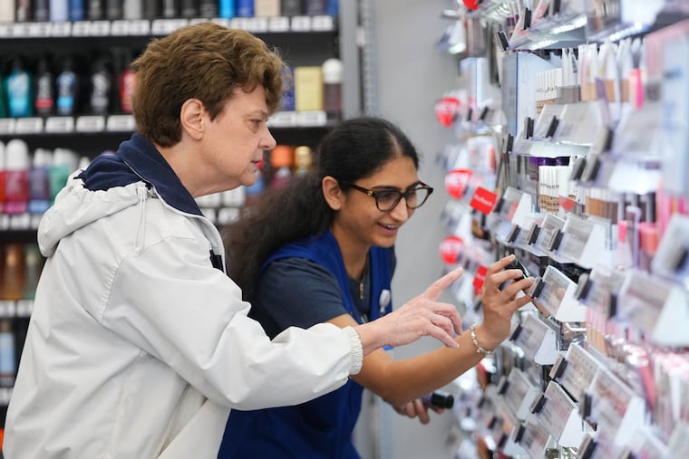 Priyanka Patil (right), fashion team lead at Walmart, helps Linda Flippin, of Colleyville, Texas, find a makeup item on the shelves near the store's beauty counter, Wednesday, April 29, 2026, in Grapevine, Texas.