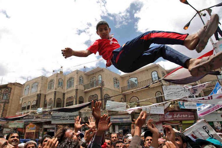 Demanding the resignation of Yemen's president, demonstrators toss a youth into the air in San'a. Saleh, in power for 32 years, warned that al-Qaeda may take over when he leaves.