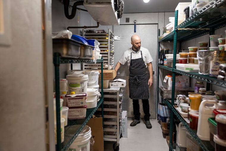 Restauranteur Greg Vernick checks the inventory inside the walk-in at Vernick Food & Drink.