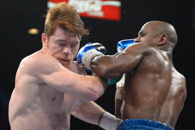 Floyd Mayweather Jr., right, lands a punch against Carlos Molina in the second round during a 152-pound title fight, Saturday, Sept. 14, 2013, in Las Vegas. (Mark J. Terrill/AP)