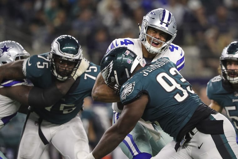Eagles defensive tackle Tim Jernigan (right) and defensive end Vinny Curry get to Cowboys quarterback Dak Prescott in the 4th quarter of the game in Dallas November 19, 2017. DAVE MAIALETTI / Staff Photographer