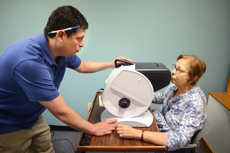 Sonia Margolis (right), 77, of Warminster, Pennsylvania had her vision tested by Dennis Magrann, a certified driver rehabilitation specialist at MossRehab Driving Program in June during evaluation for driving. She hoped to regain her license. WILLIAM THOMAS CAIN / For The Philadelphia Inquirer)