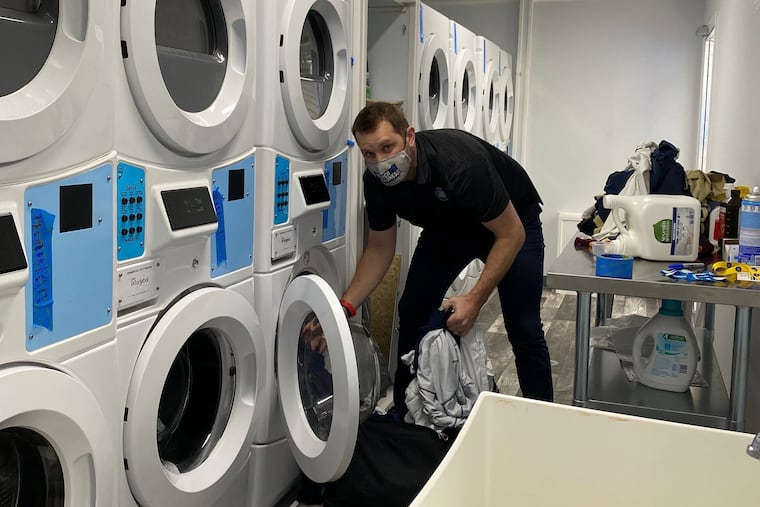 Craig Yust, senior director events for the Indiana Sports Corporation, grabs some laundry in a truck. According to Steve Sanner, Yust did laundry for 36 hours straight between Tuesday and Wednesday.