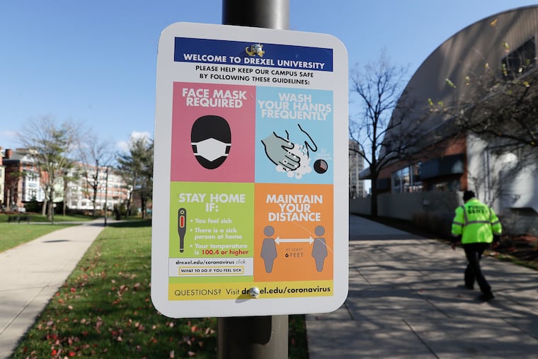 A COVID-19 safety guidelines sign hangs outside the Daskalakis Athletic Center on the Drexel University campus in 2020.