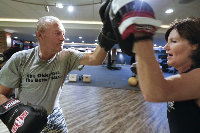 Rock Steady Boxing coach Anne Haneman (right) fends off the punches of James Brown , 70, who has been living with Parkinson’s Disease for a year and a half, during a workout at Unbound Synergy in New Hope, PA. Boxing delays the effects of the progressive movement disorder.