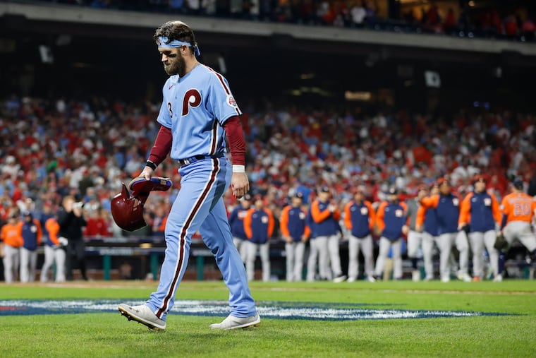 Bryce Harper walks off the field after the Phillies lost Game 5 of the World Series to the Astros.