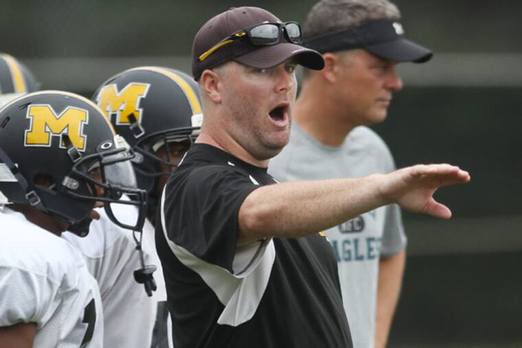 New Moorestown football coach Beau Sherry makes a point to his players during practice. (MICHAEL BRYANT / Staff Photographer)