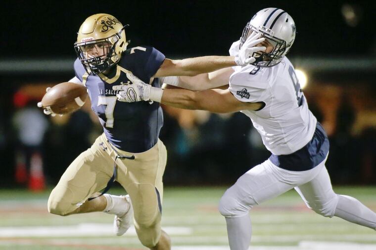 LaSalle’s Brett Mallee (left) tries stiff arms Malvern Prep’s Cole McCabe.