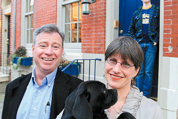Anthony and Lynda Weber, holding their dog, Hope, with son Max behind them, moved into the Catharine Street home in the 1990s.