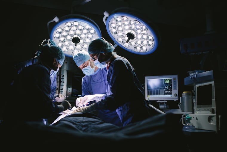 Surgeons in a hospital operating room.