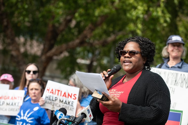 Ketty Pointe-Jour addresses the crowd at a rally organized in support of Haitian immigrants outside of the National Constitution Center in Philadelphia on Thursday.