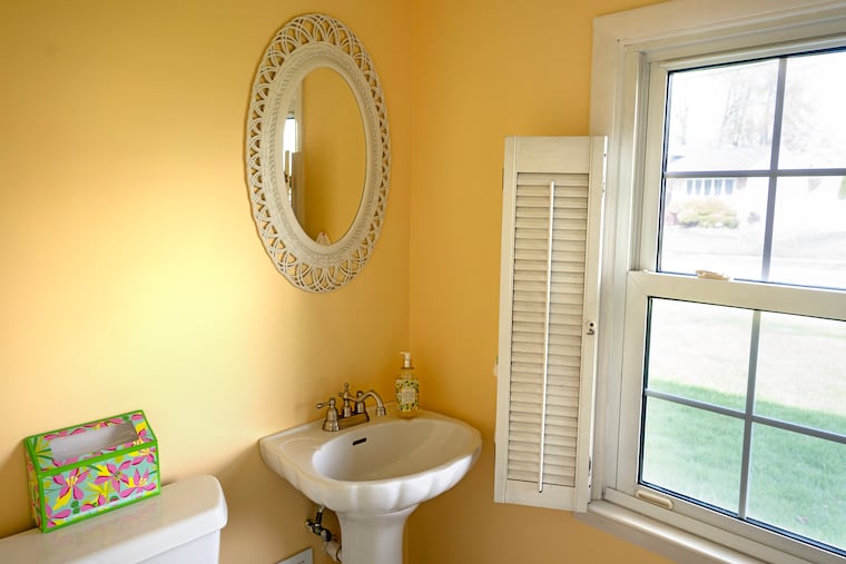 Guest powder room in the Cherry Hill home of Valerie Rossi. She painted the walls but kept the fixtures.