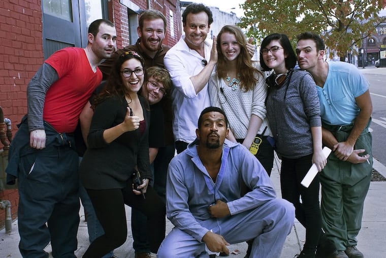 “Arrested Development” creator Mitch Hurwitz (center, in white) with some of the cast and crew of the Drexel-made comedy “Off Campus.” Hurwitz visited Philly during production of the seventh episode, one of two that will air on the CW Philly 57.