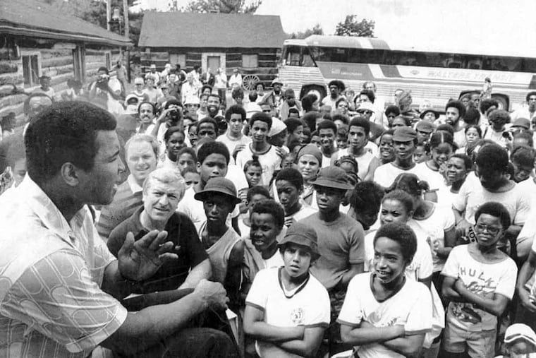 Muhammad Ali talks to a group of visitors at his training camp in Deer Lake, Pa.