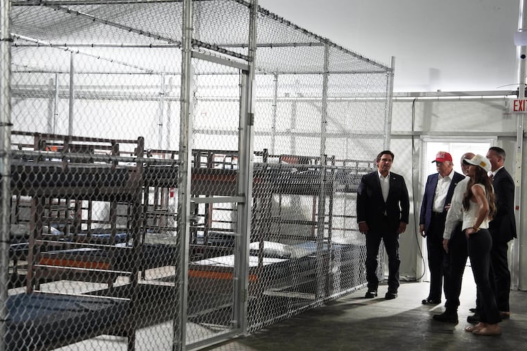 President Donald Trump, Florida Gov. Ron DeSantis, Homeland Security Secretary Kristi Noem, and others tour "Alligator Alcatraz," a new migrant detention facility at Dade-Collier Training and Transition facility, Tuesday in Ochopee, Fla.