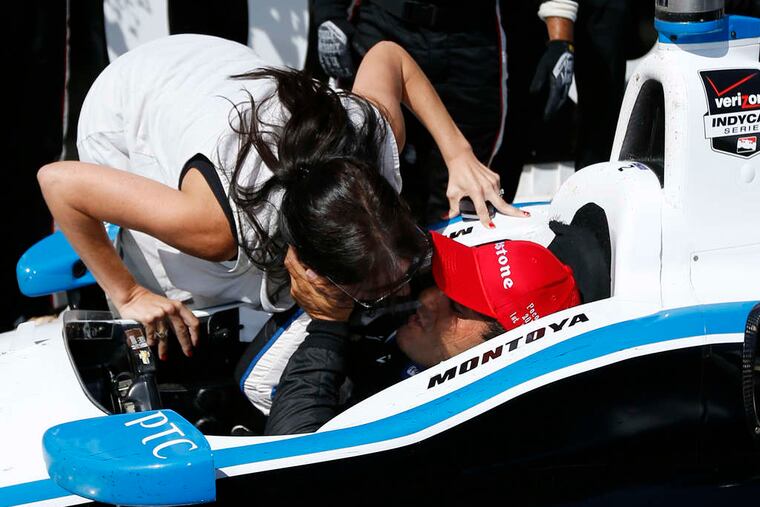 ASSOCIATED PRESS Juan Pablo Montoya gets a kiss from his wife, Connie Freydell, after he won the Pocono IndyCar 500.