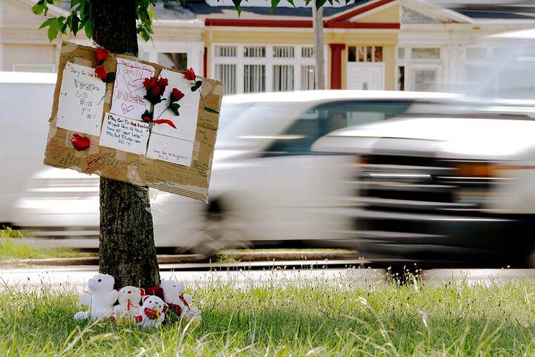 A makeshift memorial near the spot where a woman and her three young sons were struck and killed a week ago. (AP Photo / Matt Rourke)