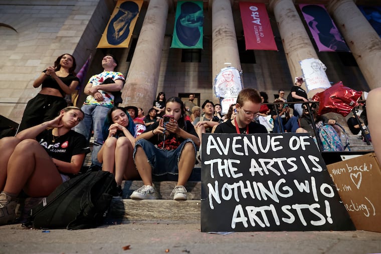Rising sophomore Kaitlyn Duska (right) sits with her sign and other students during the “Last Stand Jam” in front of the University of the Arts Dorrance Hamilton Hall on South Broad Street on June 7.