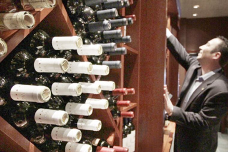 At the owner's Cherry Hill Mall, Seasons 52 employee Dan Cestare gets wine. (Elizabeth Robertson / Staff Photographer)