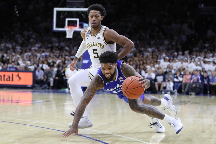 Myles Powell, right, of Seton Hall slips while being gaurded by Justin Moore of Villanova during the 1st half on Feb. 8, 2020 at the Wells Fargo Center.