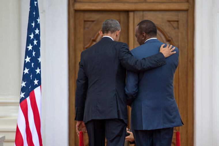 President Barack Obama, left, puts his arm on the shoulder of Kenyan President Uhuru Kenyatta as the two leave after speaking to the media at State House in Nairobi, Kenya, Saturday, July 25, 2015. (AP Photo/Ben Curtis)