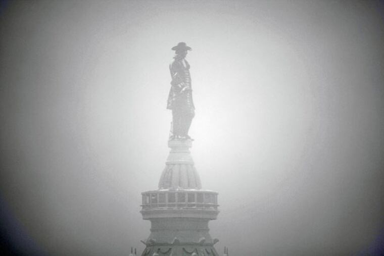 Billy Penn atop City Hall is seen from the top floor of the Loews Hotel during a snowstorm.