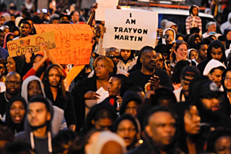 Thousands of protesters march down JFK Boulevard to raise awareness in the fatal shooting of Trayvon Martin, an unarmed Fla. teen, by a Neighborhood Watch volunteer. Philadelphia was the latest city to hold a "Million Hoodie March." Many chanted: "Do I look suspicious? I am Trayvon Martin." RON TARVER / Staff Photographer
