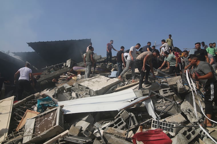 Palestinians look for survivors of the Israeli bombardment of the Gaza Strip in Rafah on Monday.