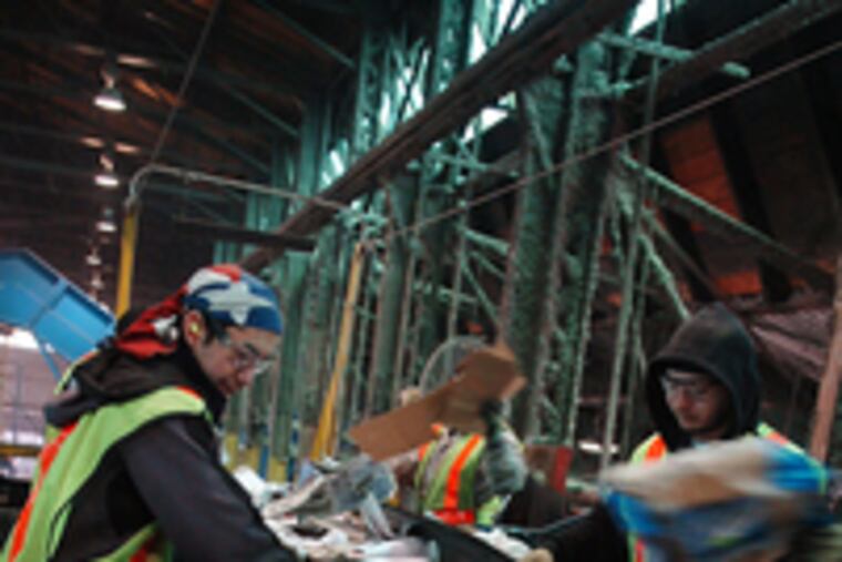 At Blue Mountain Recycling in Philadelphia , workers including Silver Guerra (left) sort paper and cardboard in the fiber line. Cherry Hill has gotten into the recycling act by teaming with RecycleBank, which provides credits for reducing trash sent to landfills