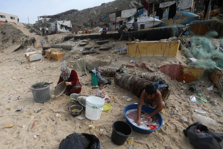 Palestinians resort to the sea water to bathe and clean their tools and clothes due to the continuing water shortage in the Gaza Strip.