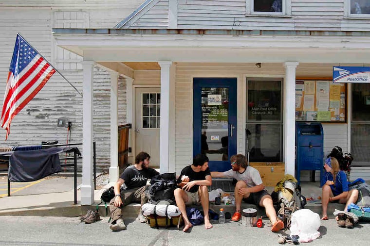 Appalachian Trail hikers ( from left) Jon Appel, Greg Brown, and David Hyman of Pleasantville, N.Y., and Madelyn Hoagland-Hanson of Philadelphia have lunch outside the post office in Caratunk, Maine.