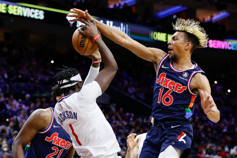 Sixers guard Charlie Brown Jr., deflects the basketball against LA Clippers guard Reggie Jackson during the second quarter Jan. 21 n Philadelphia.