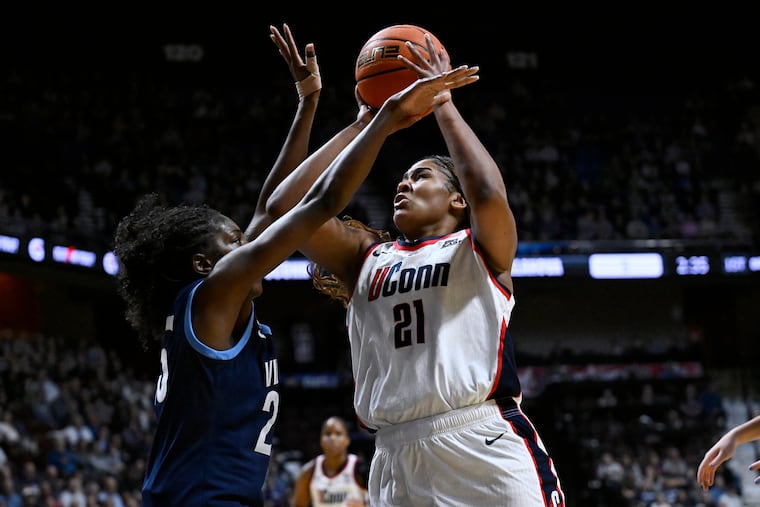UConn star forward Sarah Strong (right) drives at Villanova's Denae Carter during the first half on Monday night.
