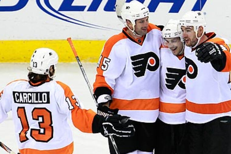 Jody Shelley, Danny Briere and Andrej Meszaros wait for Dan Carcillo as they celebrate Briere's goal in the third. (Gerry Broome/AP)