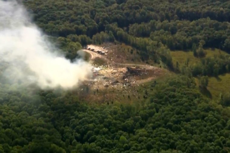 Smoke fills the air as debris covers the ground and vehicles after a powerful blast ripped through a military explosives manufacturing plant in Hickman County, Tenn., on Friday.