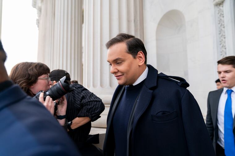 Rep. George Santos, R-N.Y., leaves the Capitol after being expelled from the House of Representatives.
