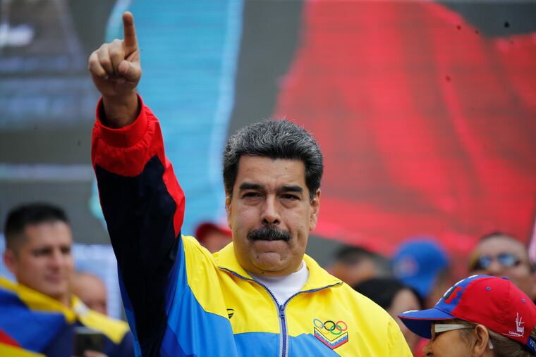 Venezuela's President Nicolas Maduro and first lady Cilia Flores, right, lead a rally condemning the economic sanctions imposed by the administration of U.S. President Donald Trump on Venezuela, in Caracas, Venezuela, Saturday, Aug. 10, 2019.